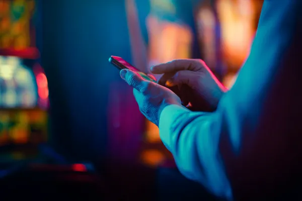 A woman in a luxurious green gown next to an ornate roulette wheel, capturing the upscale casino mood of GOOB111.